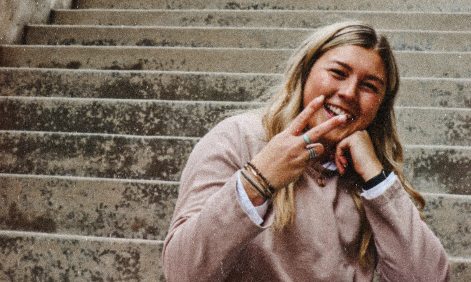 A client laughing on a park bench, phone in hand